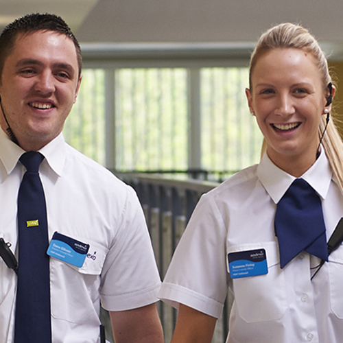 Male and female prison officer walking through a prison